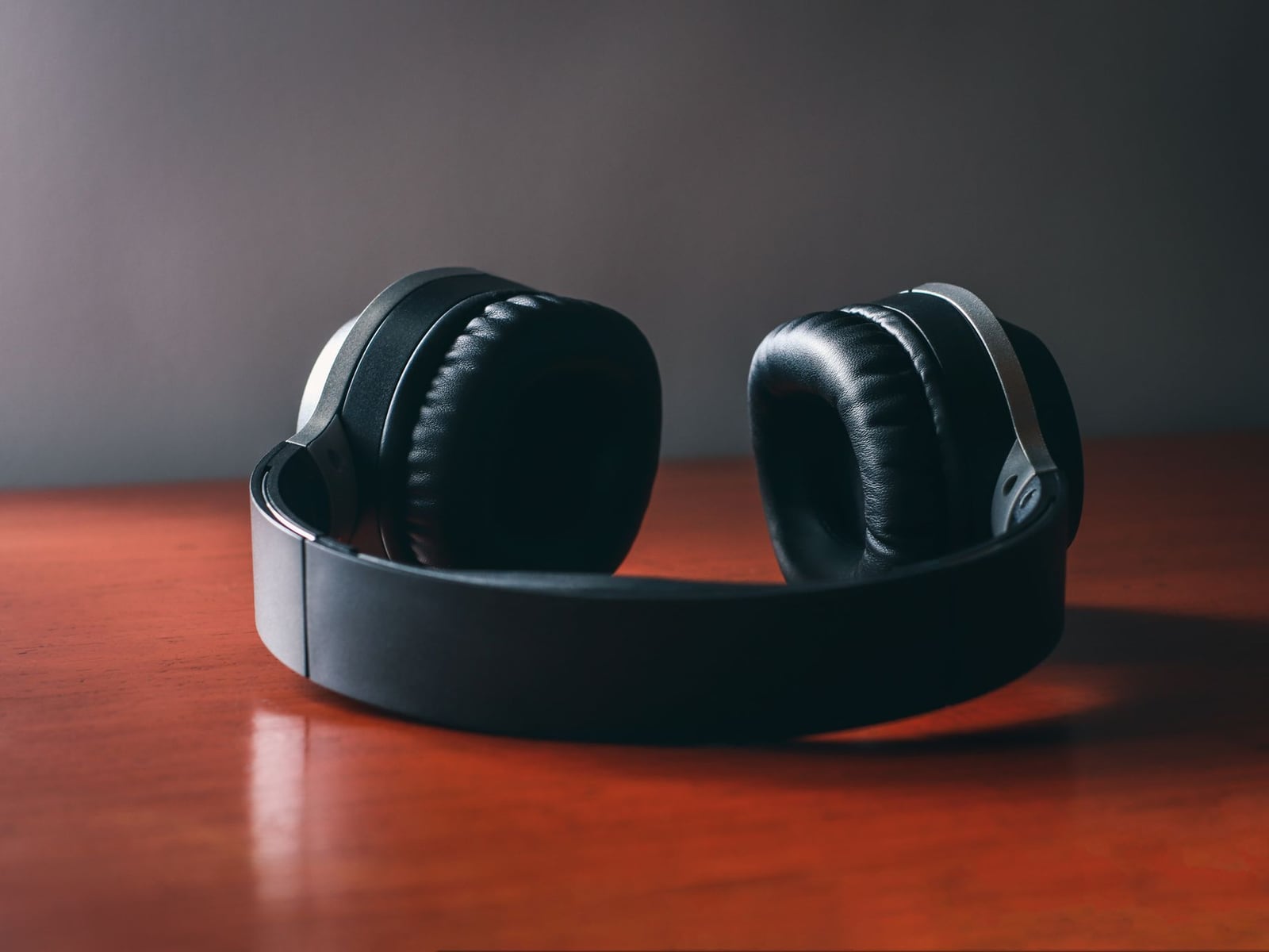 Professional studio headphones on a desk, representing final quality control for streaming platforms.