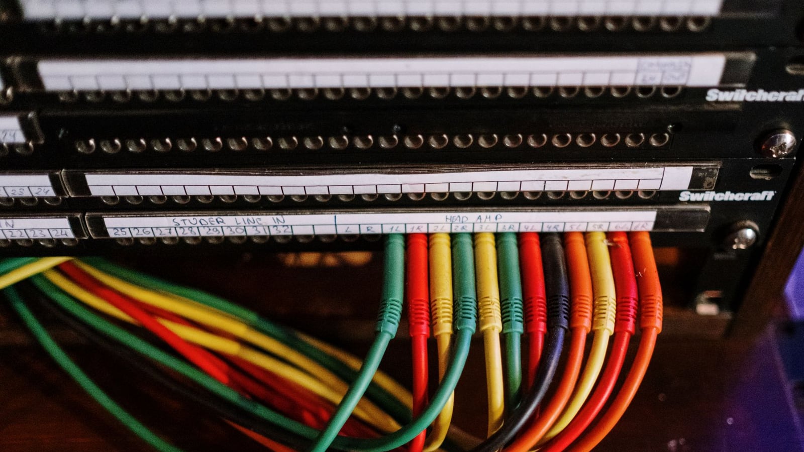 Organised audio cables and storage drives, illustrating the preparation of stems for mixing.